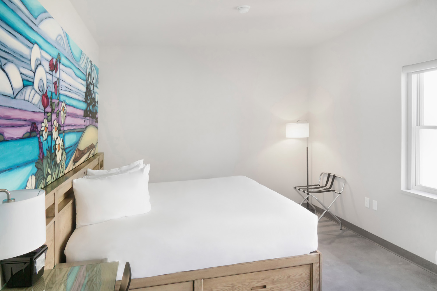 Guest room with painted mural headboard