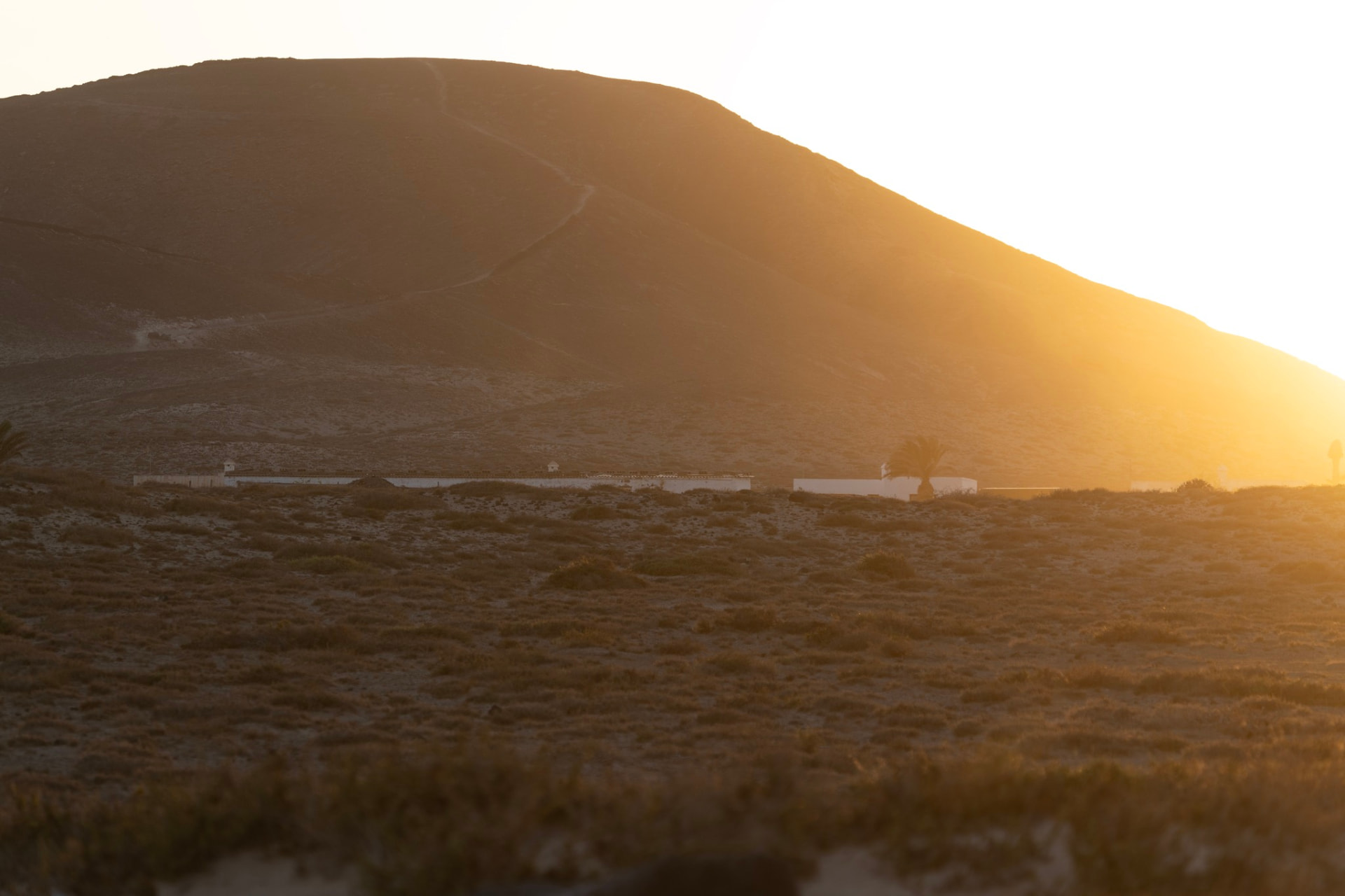 Sunlight breaking over a coastal hillside