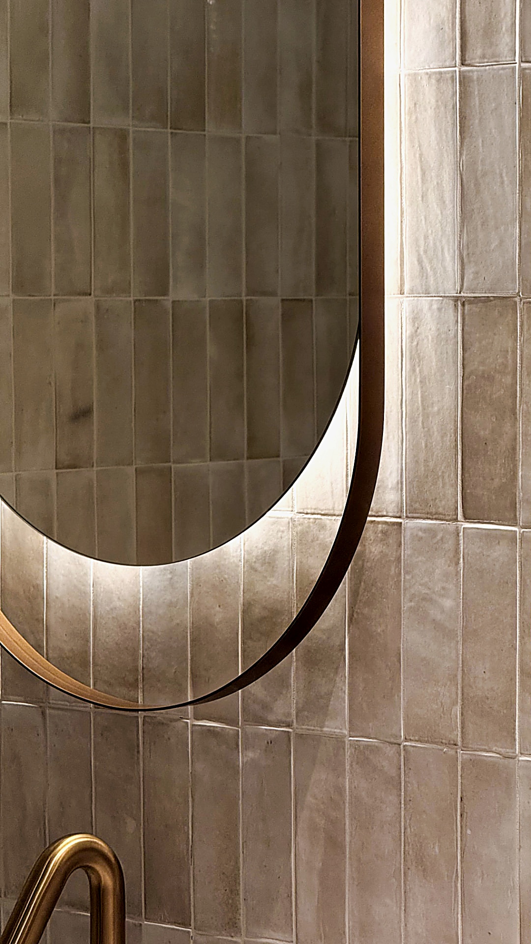 Curved mirror and tactile tiled wall detail