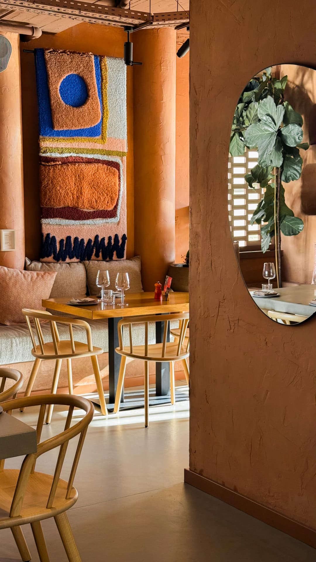 Sculptural pendant lights against a warm interior wall